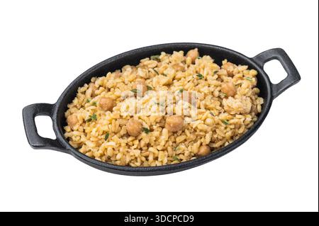 Turkish bulgur pilaf with chickpeas served in cast iron pan with thyme isolated on white background top view. Stock Photo