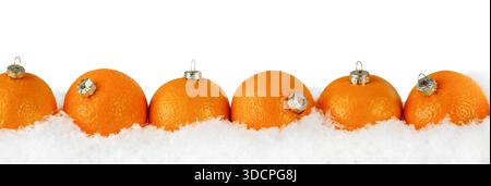 Mandarins or tangerines in form of christmas fir tree ornament in snowdrift with falling snow isolated on white background with clipping path. Banner Stock Photo