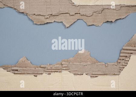 Torn Corrugated Cardboard Texture Background, Ripped Brown Kraft Paper with Peeling Layers. Stock Photo