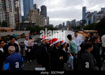 Melbourne, Australia. 24th Dec, 2025. Crowds gather near Flinders Street Station, enjoying the festive Christmas eve lights and decorations. Residents and visitors gather across Melbourne on Christmas Eve, as festive decorations, markets, and illuminated city streets draw crowds for seasonal celebrations. (Photo by Ye Myo Khant/SOPA Images/Sipa USA) Credit: Sipa USA/Alamy Live News Stock Photo