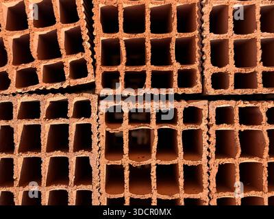 Brick wall background showcasing several stacked hollow bricks with grid-like openings. Mobile photo Stock Photo