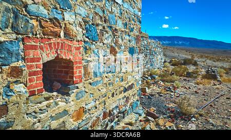 Abandoned Stone and Brick Mine Wall with Desert Landscape in California Stock Photo