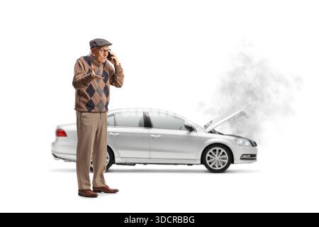 Full length shot of an angry elderly driver calling for help after car breakdown isolated on white background Stock Photo