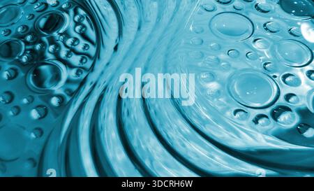 Textured light blue glass block wall featuring wavy water pattern and embossed circular bubble details. Abstract glass texture is perfect for modern a Stock Photo