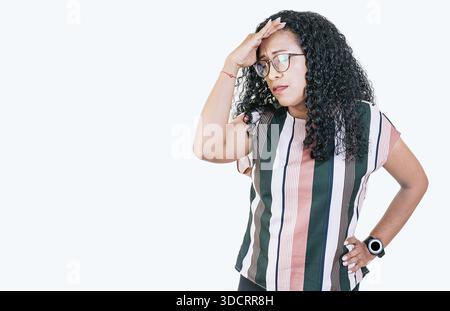 Worried young woman holding his forehead. Worried people isolated holding his head. Tired afro woman holding his head isolated Stock Photo