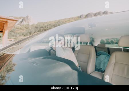 Woman in a White Sweater Driving a Car Stock Photo