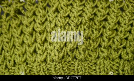 Knitting pattern using thick, green yarn. Details for knitting sweaters, hats, and other knitted items. Handicrafts. Stock Photo