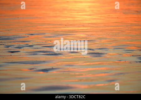 Sunset on the Atlantic coast. Reflections in the water in pastel tones. Stock Photo