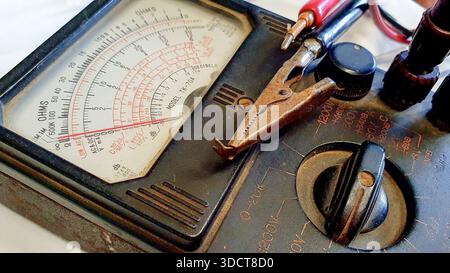 Vintage analog voltmeters are classic electrical measuring instruments, used to measure the difference in electrical potential (voltage) in a circuit Stock Photo
