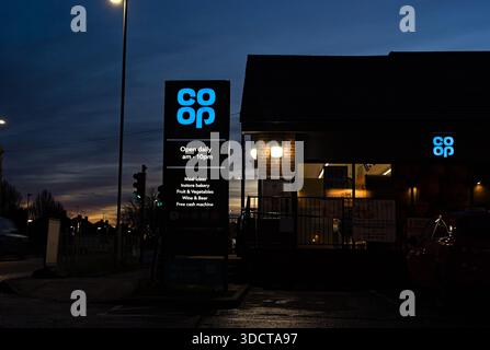 Co-op convenience store with lit up signs after sundown on London road Stock Photo