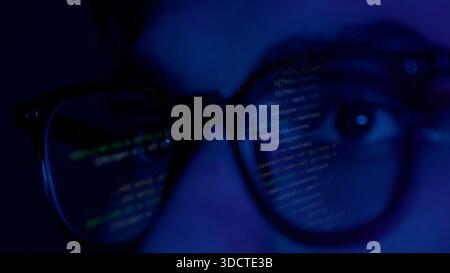 Close up of man's face with binary code reflection on glasses Stock Photo