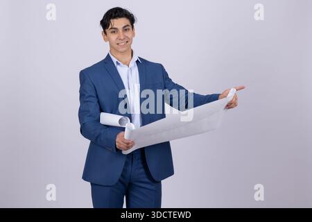 Businessman in blue suit showing a paper blueprint Stock Photo