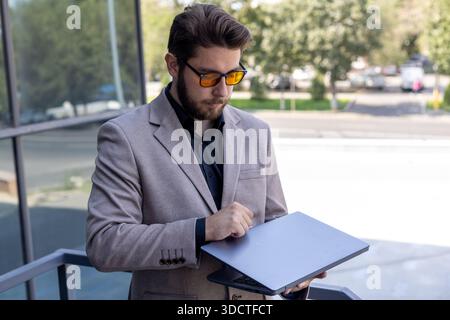 Businessman in suit making notes on a clipboard Stock Photo