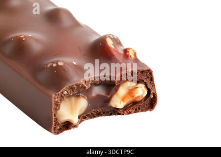 Close up view of a bitten milk chocolate bar revealing the inner texture of aerated cocoa sponge, caramel and whole hazelnuts isolated on a white back Stock Photo