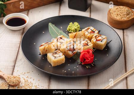 Tempura sushi rolls with sauce and sesame Stock Photo