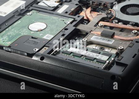 Comprehensive view of laptop internals showing circuit complexity, capacitors, and chips. Represents the electronic supply chain and hardware market d Stock Photo