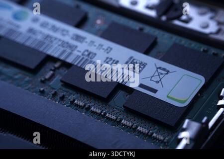Extreme close-up focusing on the specification sticker and waste bin symbol on a laptop RAM stick. emphasize e-waste awareness and technical product d Stock Photo