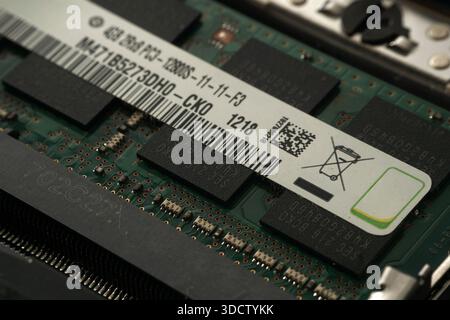 Extreme close-up photography of the product label on a laptop RAM stick, clearly showing serial numbers, barcodes, QR codes, and technical specs like Stock Photo