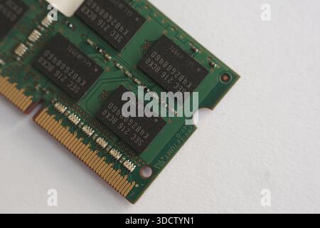 Overhead macro shot focusing on the central memory chips and small resistors of a RAM stick. Shows the intricate layout of computer electronics. Stock Photo