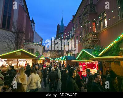 Freiburg im Breisgau, Germany, December 19, 2025, Famous Christmas market in the old town during golden blue hour Stock Photo