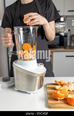 Making Fresh Orange Juice with Blender – Citrus Smoothie Preparation, Healthy Nutrition, Home Cooking and Detox Lifestyle Concept Stock Photo