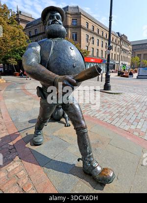 Bronze statue of Desperate Dan, a character from The Beano comic, striding through the Overgate area of Dundee city centre, Dundee DD1 1UF, Scotland Stock Photo