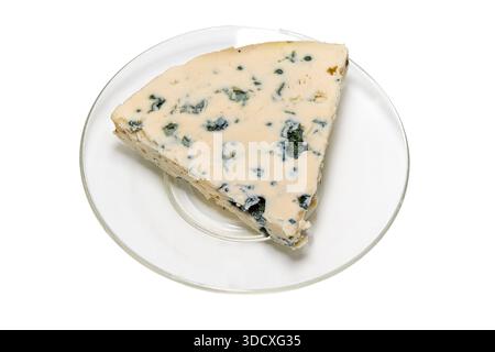 A single wedge of soft blue cow cheese with characteristic blue-green spots of edible mold served on a clear glass plate against white background. Stock Photo