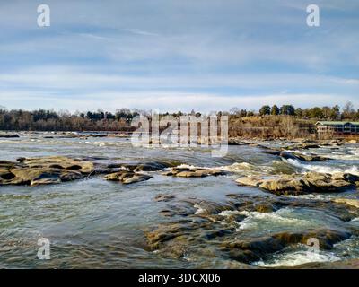Powerful river current flowing over large smooth rocks Stock Photo