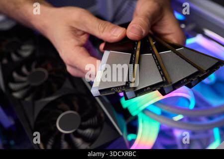 Computer hardware setup highlighting RAM sticks and graphics card details, Credentials for professional technical environment featuring RAM modules Stock Photo