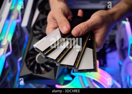 Computer hardware setup highlighting RAM sticks and graphics card details, Credentials for professional technical environment featuring RAM modules Stock Photo