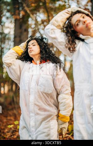Young women beekeepers preparing for beekeeping activity in nature Stock Photo