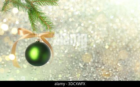 Christmas ball hanging from fir tree branch against festive background. Banner design Stock Photo