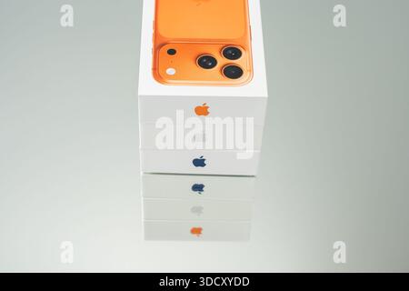 Germany Berlin December 25, 2025. Stacked iPhone 17 Pro boxes showing Apple logos in multiple colors. Vertical composition highlights branding consist Stock Photo
