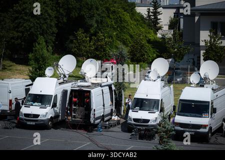 Outside broadcast vans with satellite dishes parked at a location, providing infrastructure for live television events Stock Photo