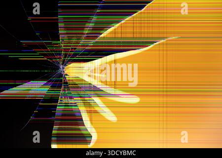 Close-up of a broken LCD screen showing abstract yellow shapes and a spiderweb crack, with horizontal and vertical multicolored pixel lines for data c Stock Photo