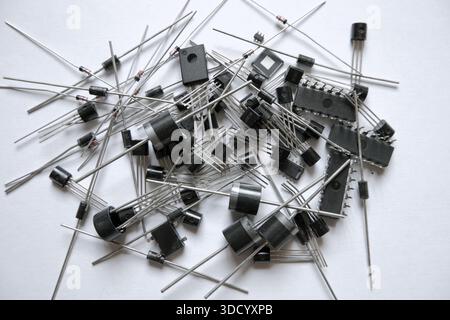 Heap of semiconductor electronic components. Diodes, integrated circuits, transistors, microchips. Stock Photo