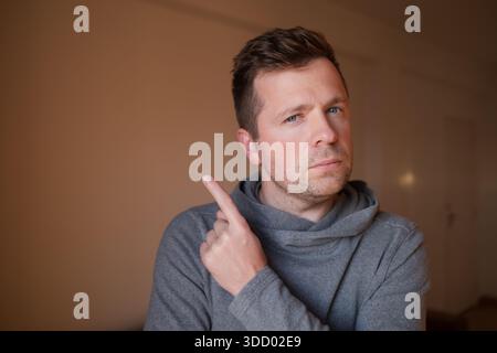 Middle Aged European Man Pointing Up with Index Finger Stock Photo