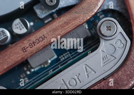 Extreme close-up of a copper thermal heat pipe and mounting screw inside a laptop. Visualizes thermal management and hardware assembly. Stock Photo