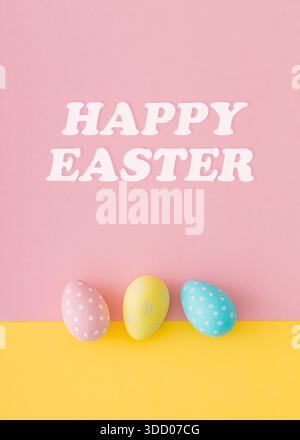 Spring composition with colorful Easter eggs on pastel pink and yellow background. Creative Easter concept. Festive holiday layout. Flat lay. Stock Photo