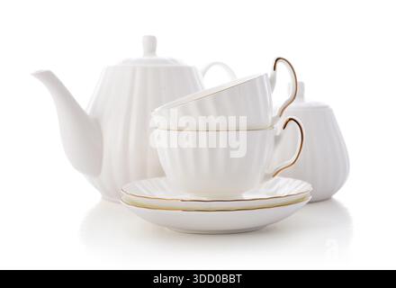 Two white golden rimmed porcelain tea cups with saucers, a bone china teapot and a sugar bowl isolated on white background, clipping path included Stock Photo