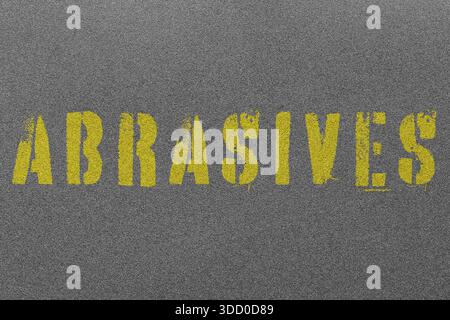 Wet and dry black fine grit sandpaper background with the word abrasives stenciled in yellow. Do it youself decorating supplies concept Stock Photo