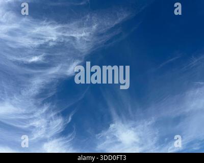 Blue sky with gentle wispy clouds Stock Photo