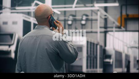 On Site Monitoring, Technician Responding Alerts in Data Center. Technician in Glasses Walking and Responding System Alerts Via Cell Phone. Concept of Mobile Management and Quick Resolution of Issues. Stock Photo