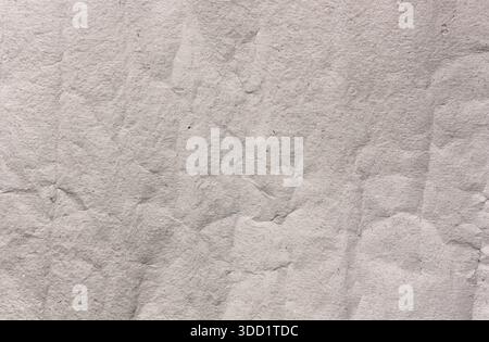 Soft handmade grey paper texture background with gentle subtle folds and creases, minimal elegant surface ideal for backgrounds, stationery, branding Stock Photo