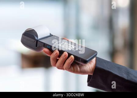 POS terminal displaying QR code payment interface, representing digital wallet transactions, mobile payments, and modern fintech solutions in retail e Stock Photo