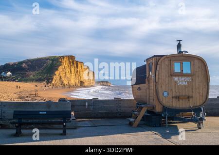 The Bayside Sauna overlooking the dramatic West Bay cliffs and beach in Bridport harbour on the Jurassic coast in Dorset Stock Photo