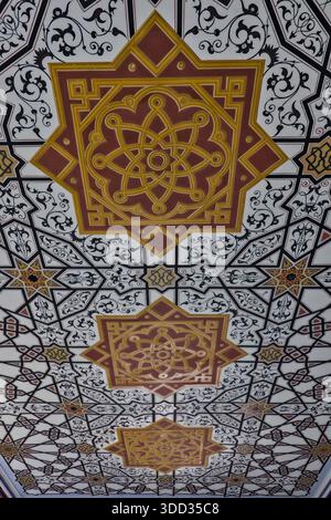 A striking ceiling pattern showcasing a complex lattice of black and white geometric stars. Stock Photo