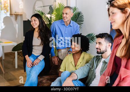 Diverse business team collaborating during a casual meeting Stock Photo