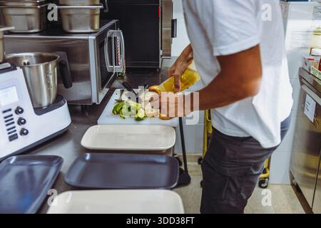 Vegan chef preparing avocado toast in restaurant kitchen workstation. Stock Photo