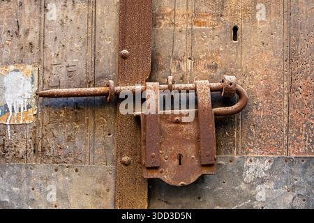 metal padlock on old wooden doors. Travels in Italy Stock Photo